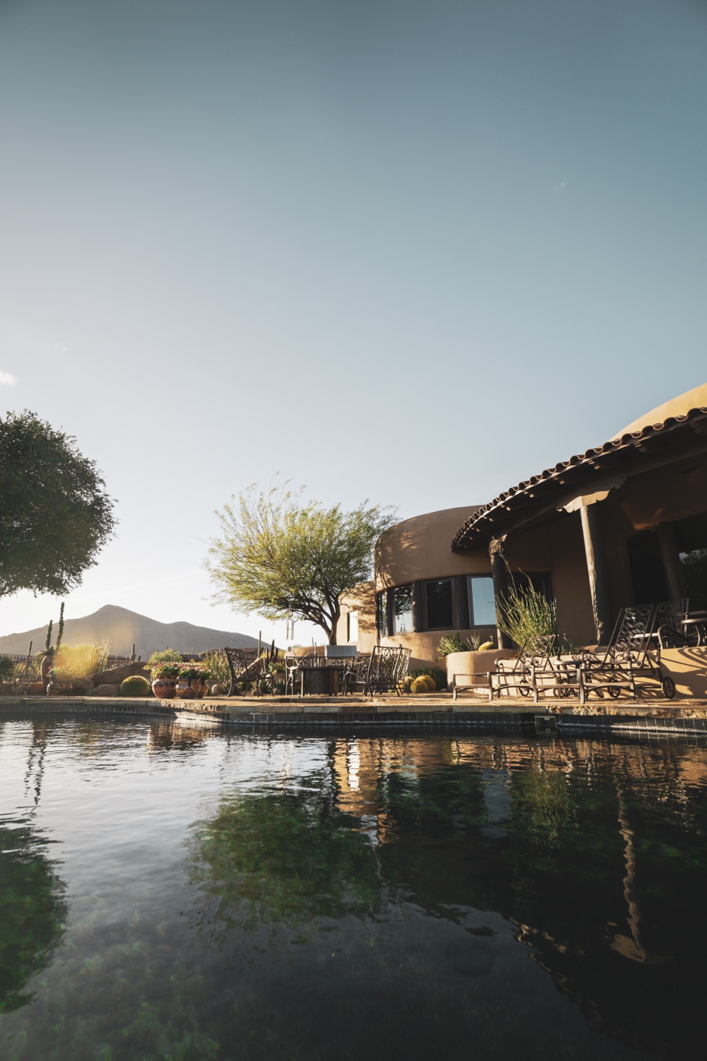Real estate — twilight modern home, lit pool