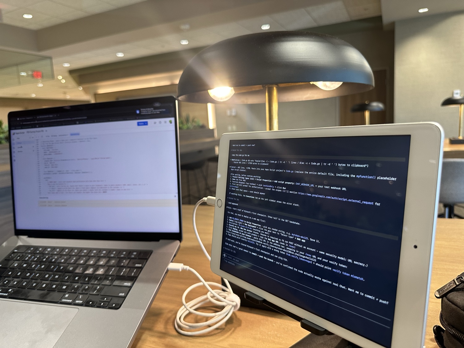 Workspace — MacBook and iPad side by side at a desk, code on both screens